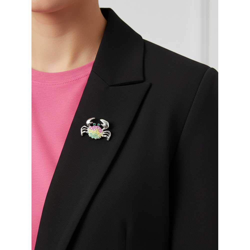 Model wearing pink yellow and green pastel crystal crab brooch pin on a black jacket - Lilylin Designs