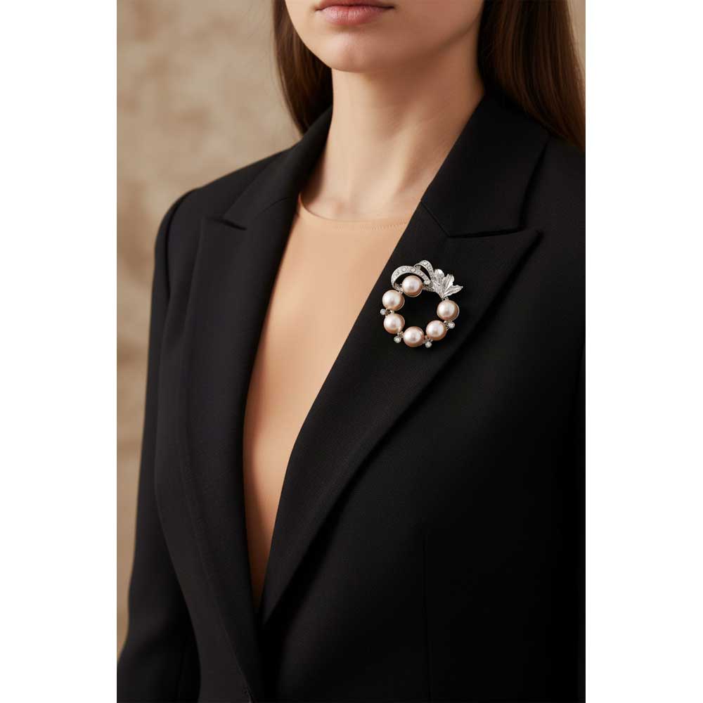 Model wearing Peach pearl wreath brooch pin on a black jacket - Lilylin Designs