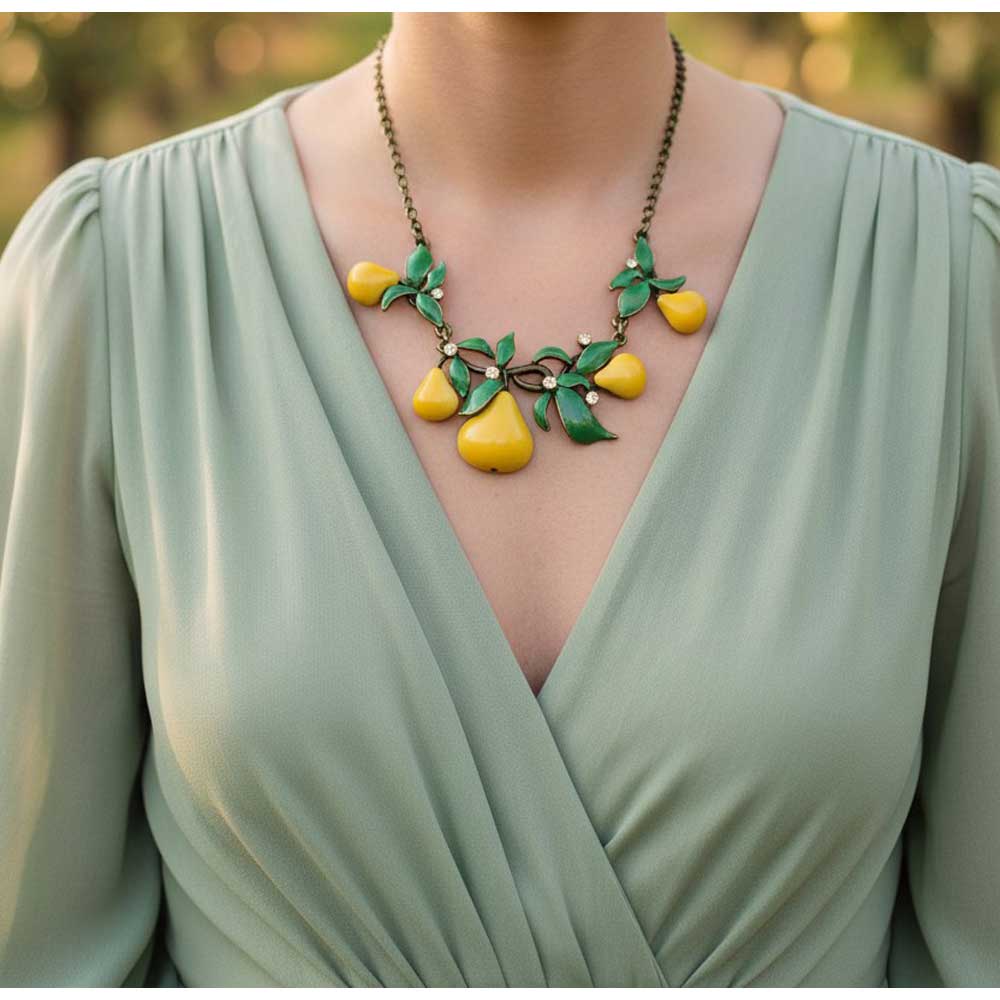 Model wearing Pears and leaves necklace with a green dress - Lilylin Designs