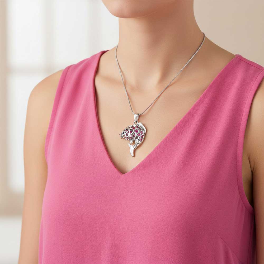 Model wearing Pink crystal fish necklace with a pink top - Lilylin Designs