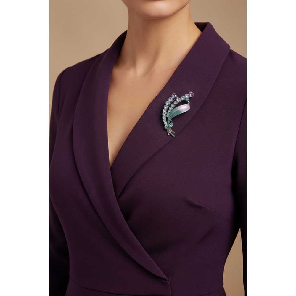 Model wearing Purple and green crystal leaf brooch pin on a maroon purple wrap dress - Lilylin Designs