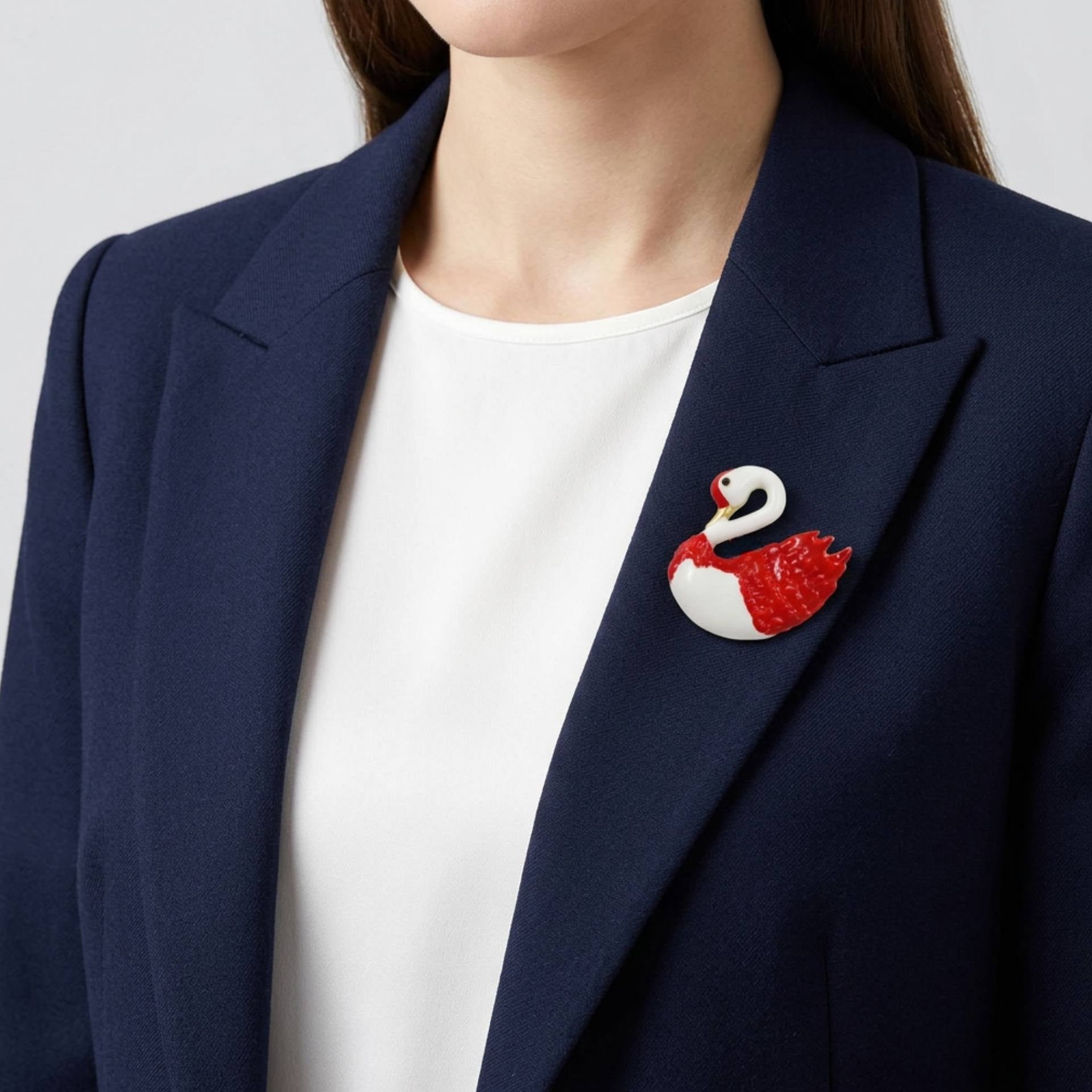 Model wearing red and white swan brooch pin on a navy blue jacket - Lilylin Designs