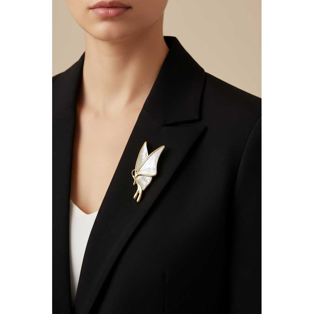 Model wearing Shell butterfly brooch pin on a black jacket with a white top - Lilylin Designs