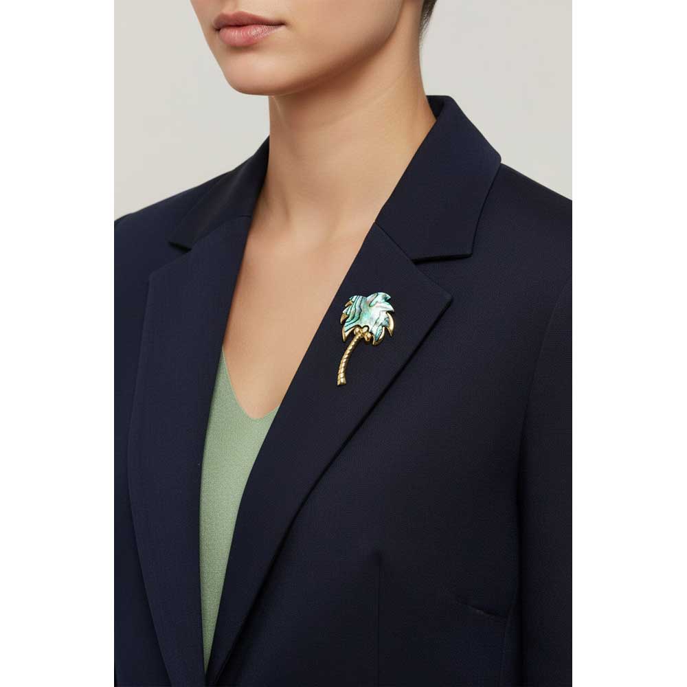 Model wearing Shell coconut tree brooch pin on a navy blue jacket with a green shirt - Lilylin Designs
