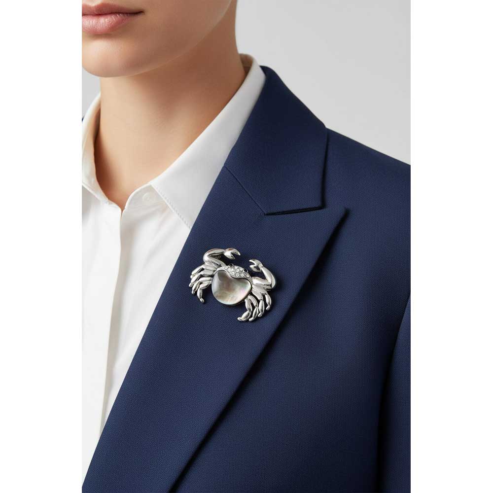 Model wearing Shell crab brooch pin on a blue jacket - Lilylin Designs