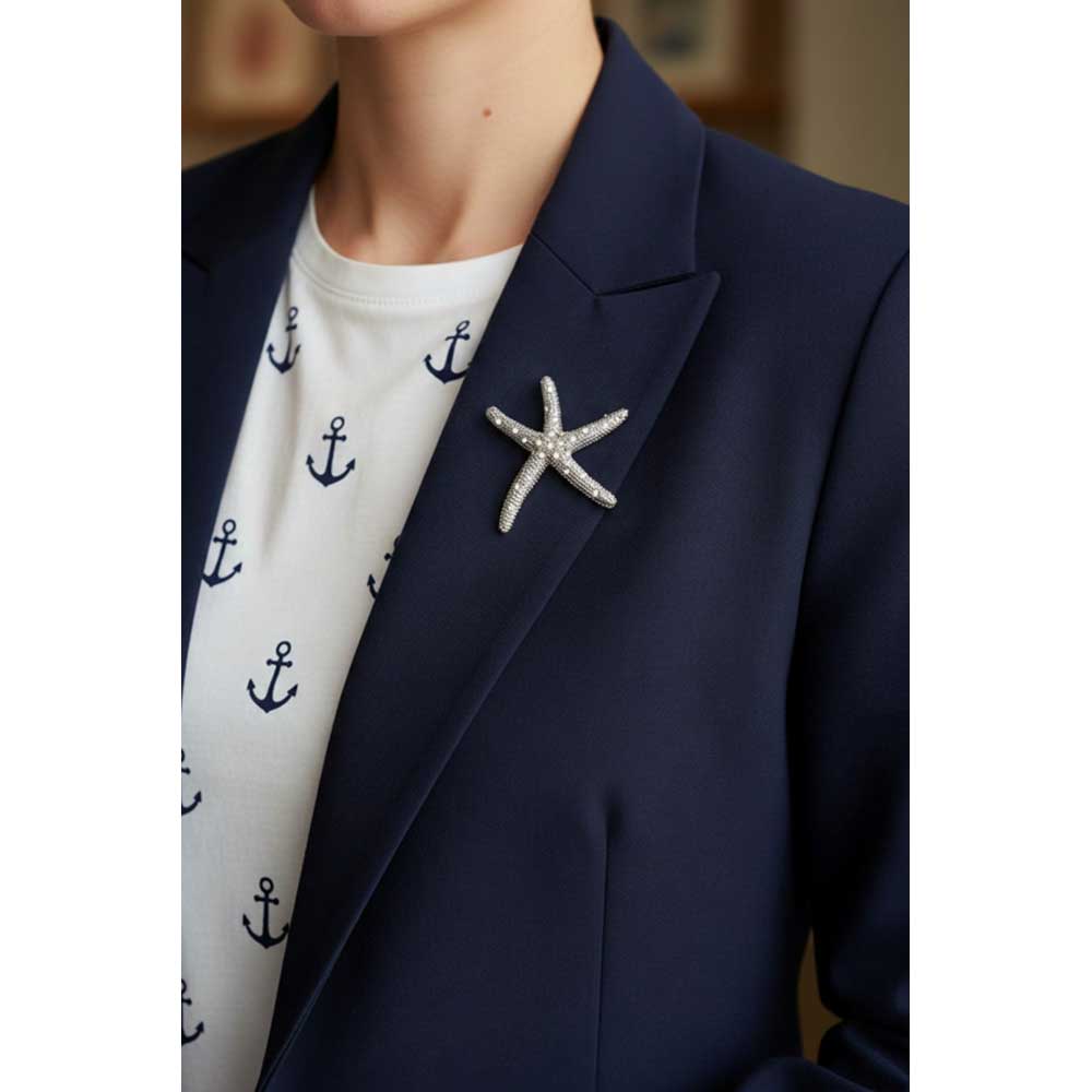 Model wearing a Silver starfish brooch pin on a blue jacket - Lilylin Designs