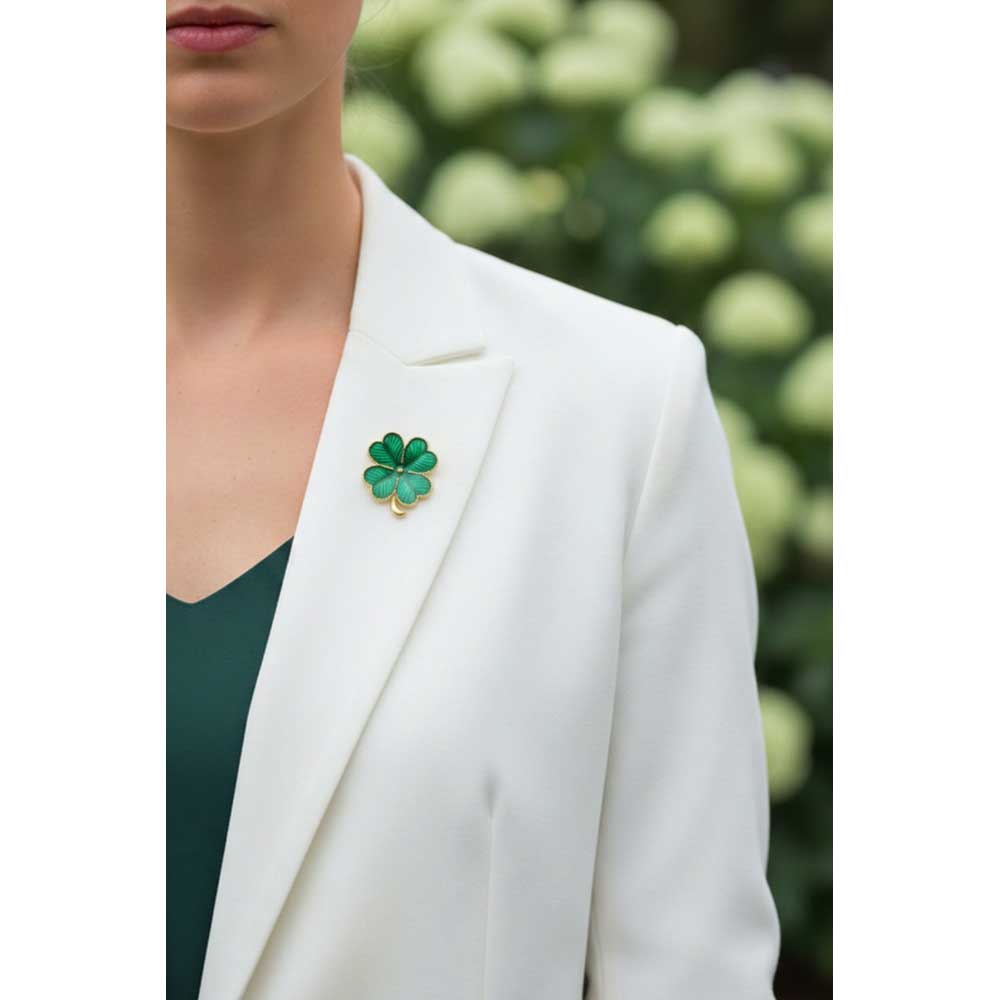 Model wearing Small 4 leaf clover lapel tac pin on a white jacket with a green top with blurred hydrangeas in the background - Lilylin Designs