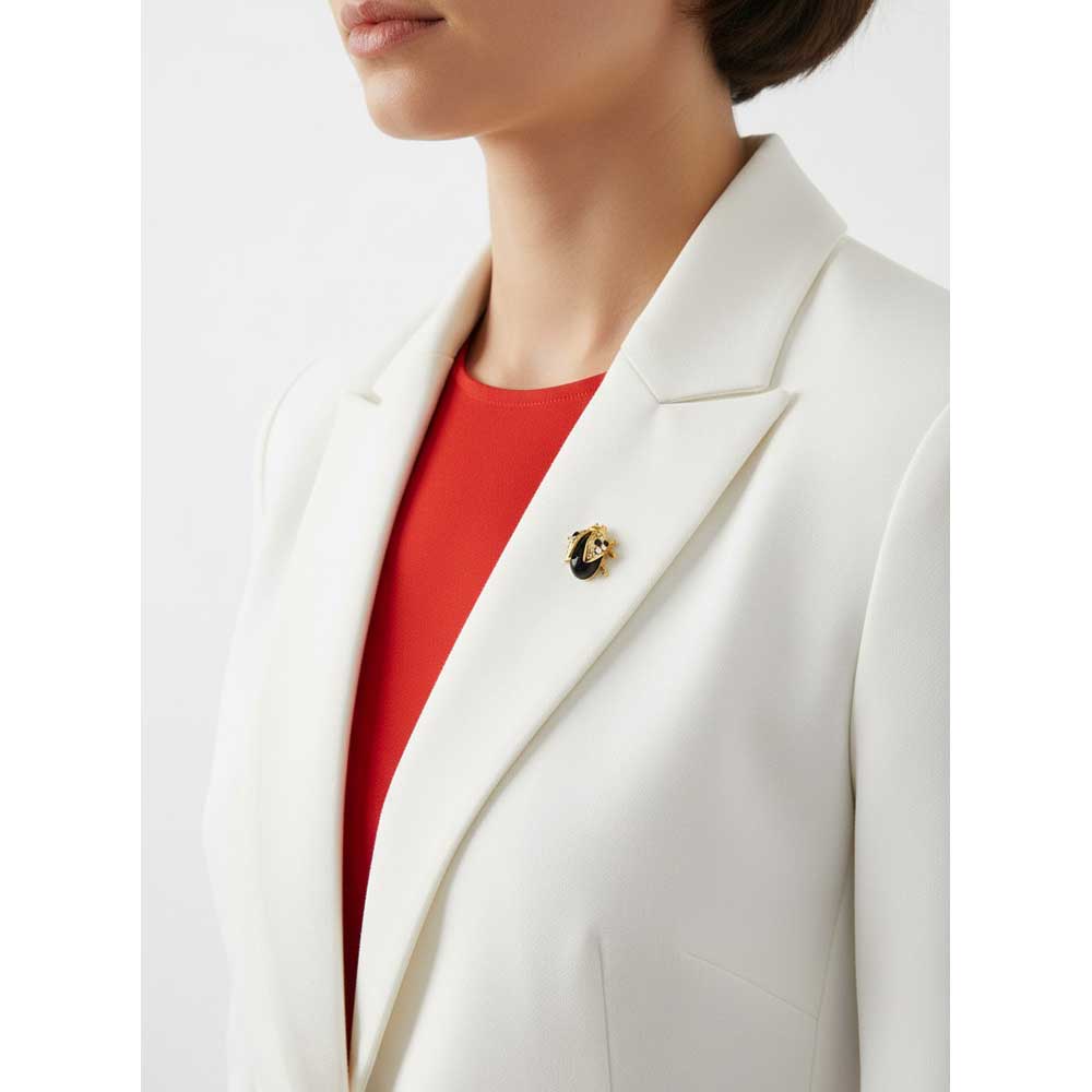 Model wearing Small black ladybug lapel tac pin on a white jacket with a red top - Lilylin Designs