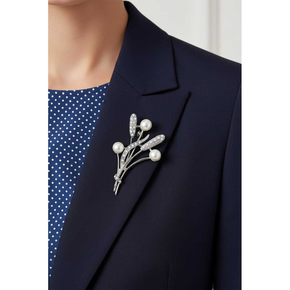 Model wearing White Pearl Buds with Cattails Brooch Pin  on a blue jacket with a blue and white top - Lilylin Designs