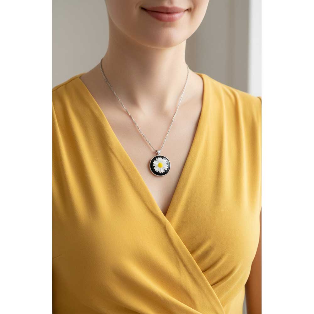 Model wearing Lilylin Designs black with white daisy necklace with a yellow dress