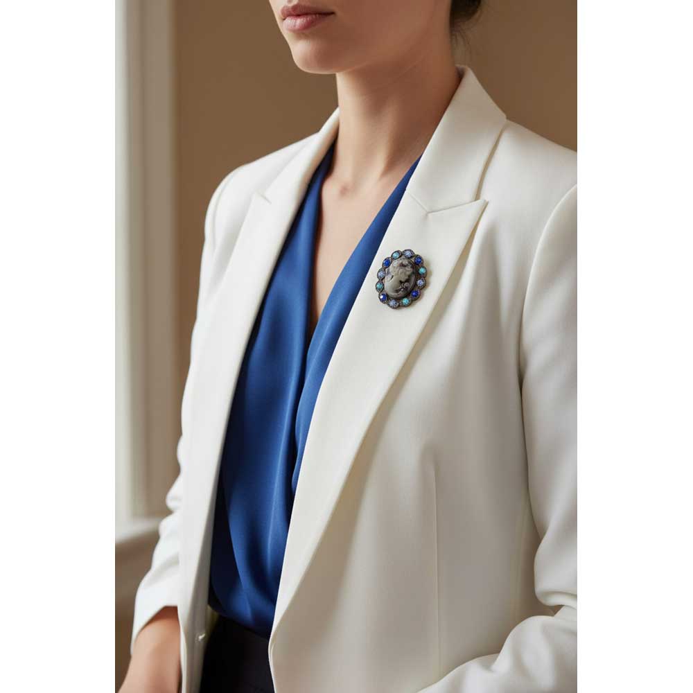 Model wearing blue cameo brooch pin on a white jacket with a blue top - Lilylin Designs