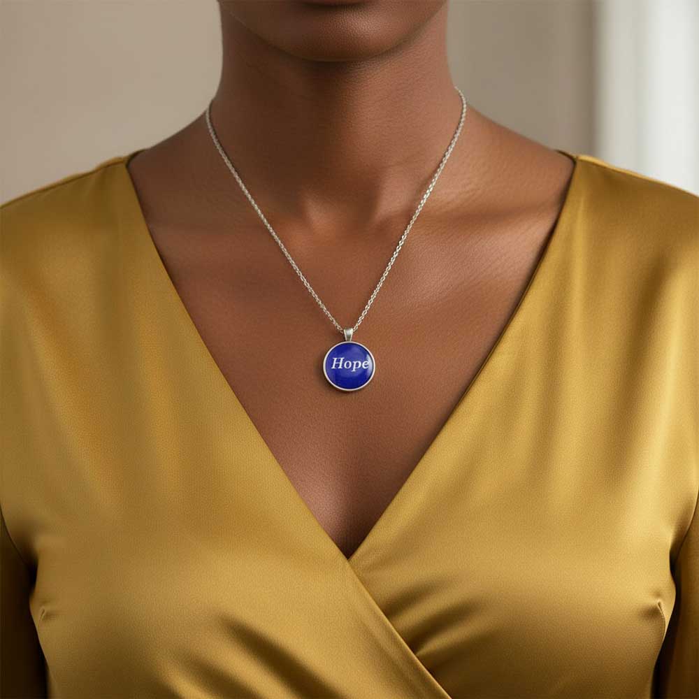 Model wearing Lilylin Designs handcrafted blue with white "Hope" necklace with a gold dress