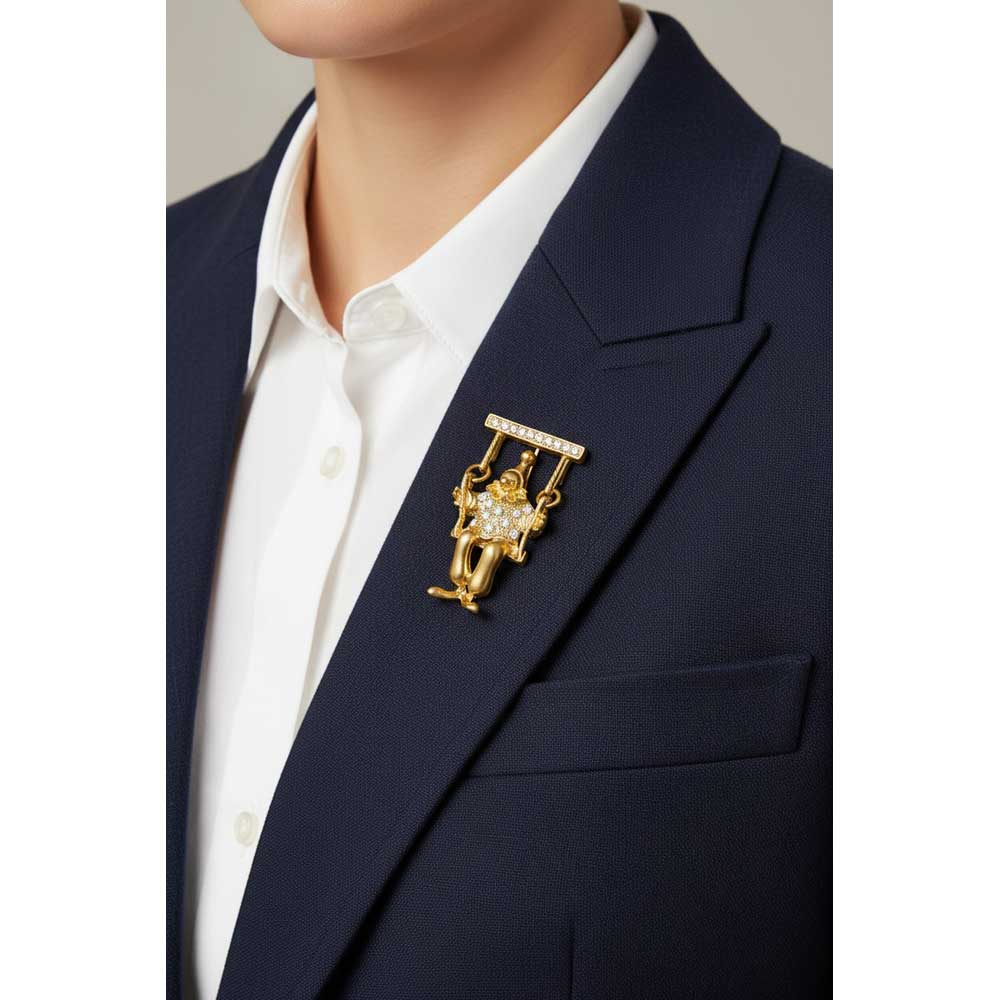 Model wearing gold and crystal clown on a swing brooch pin on a navy blue jacket with a white shirt - Lilylin Designs