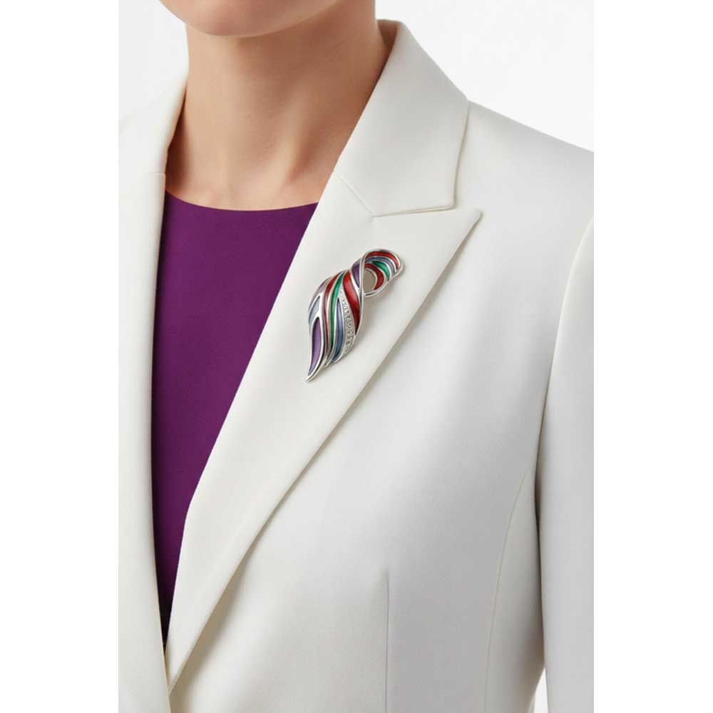 Model wearing colorful enamel and crystal wave brooch on a white jacket with a purple shirt - Lilylin Designs