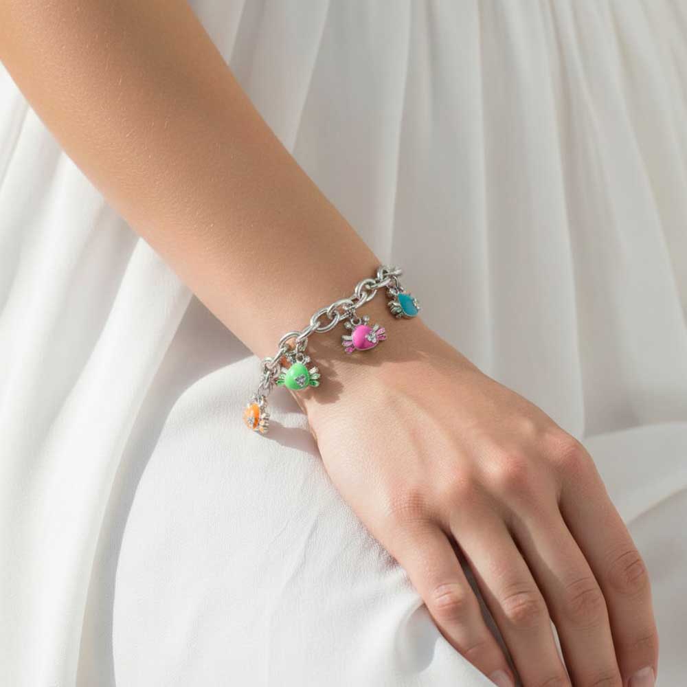 A silver chain bracelet with colorful crab charms, worn on a woman's wrist against a soft white dress background. Lilylin Designs