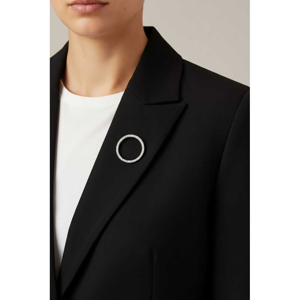 Model wearing crystal infinity circle brooch pin on a black jacket with a white shirt - Lilylin Designs