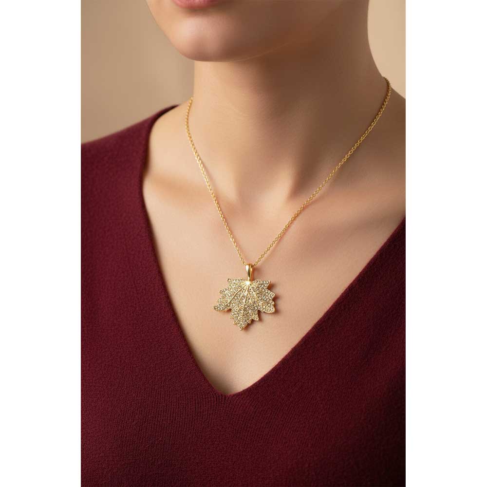 Model wearing crystal maple leaf necklace with a maroon top - Lilylin Designs