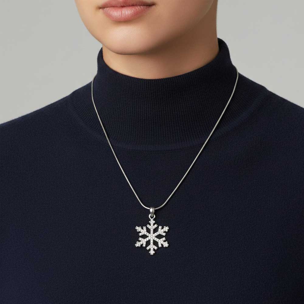 Model wearing crystal snowflake necklace on a navy blue turtle neck sweater - Lilylin Designs