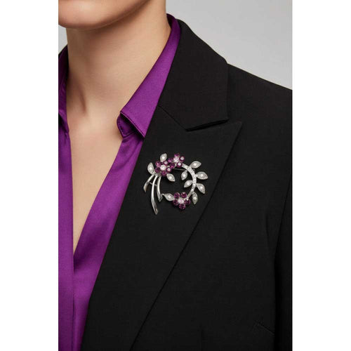 Model waring curved branch with purple crystal flowers brooch pin on a black jacket with a purple shirt - Lilylin Designs