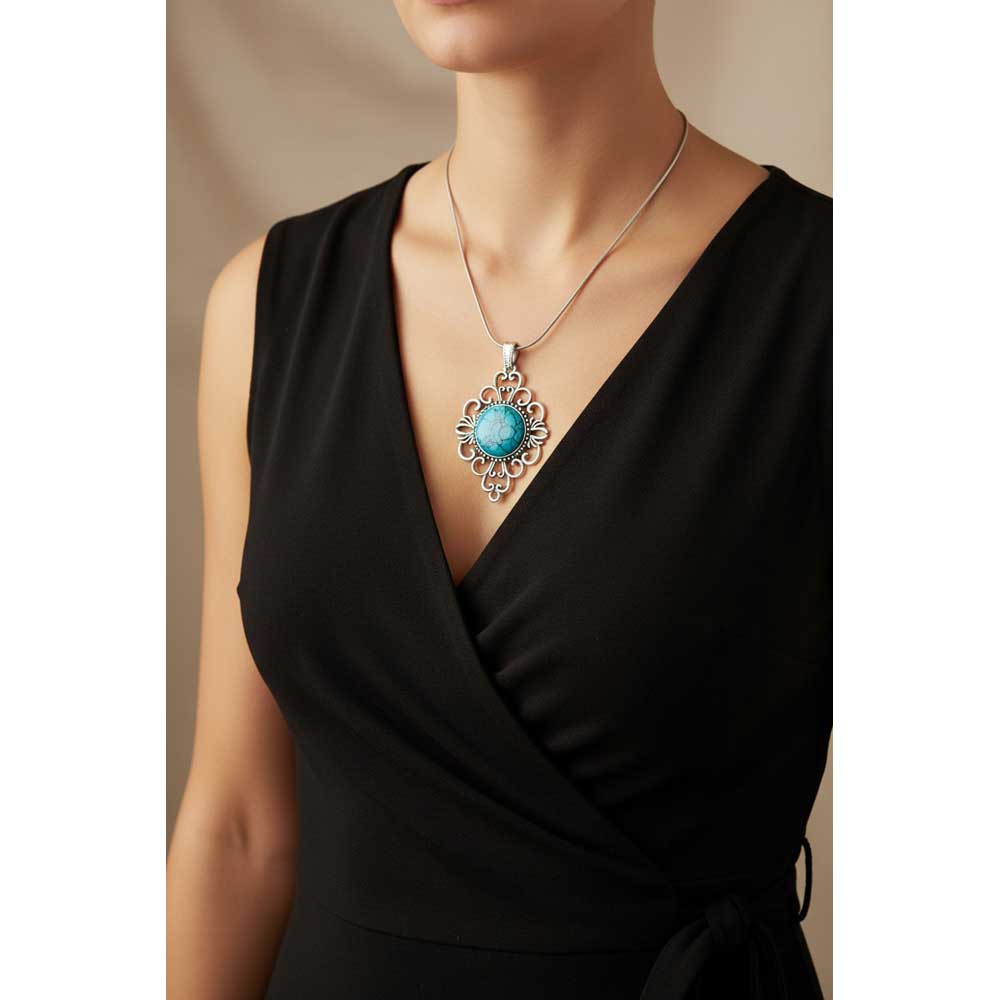 Model wearing Lilylin Designs filigree turquoise necklace with a black wrap dress