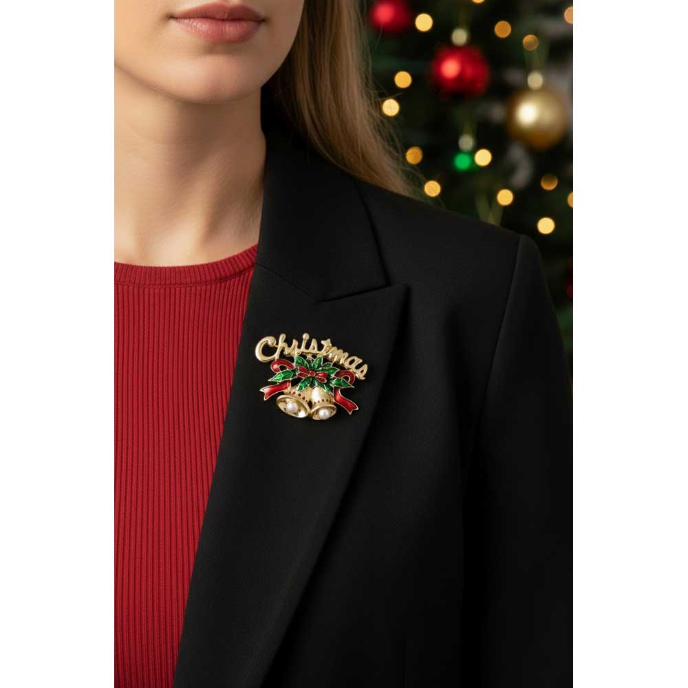 Model wearing gold Christmas bells brooch pin on a black jacket with a red top with blurred holiday background - Lilylin Designs
