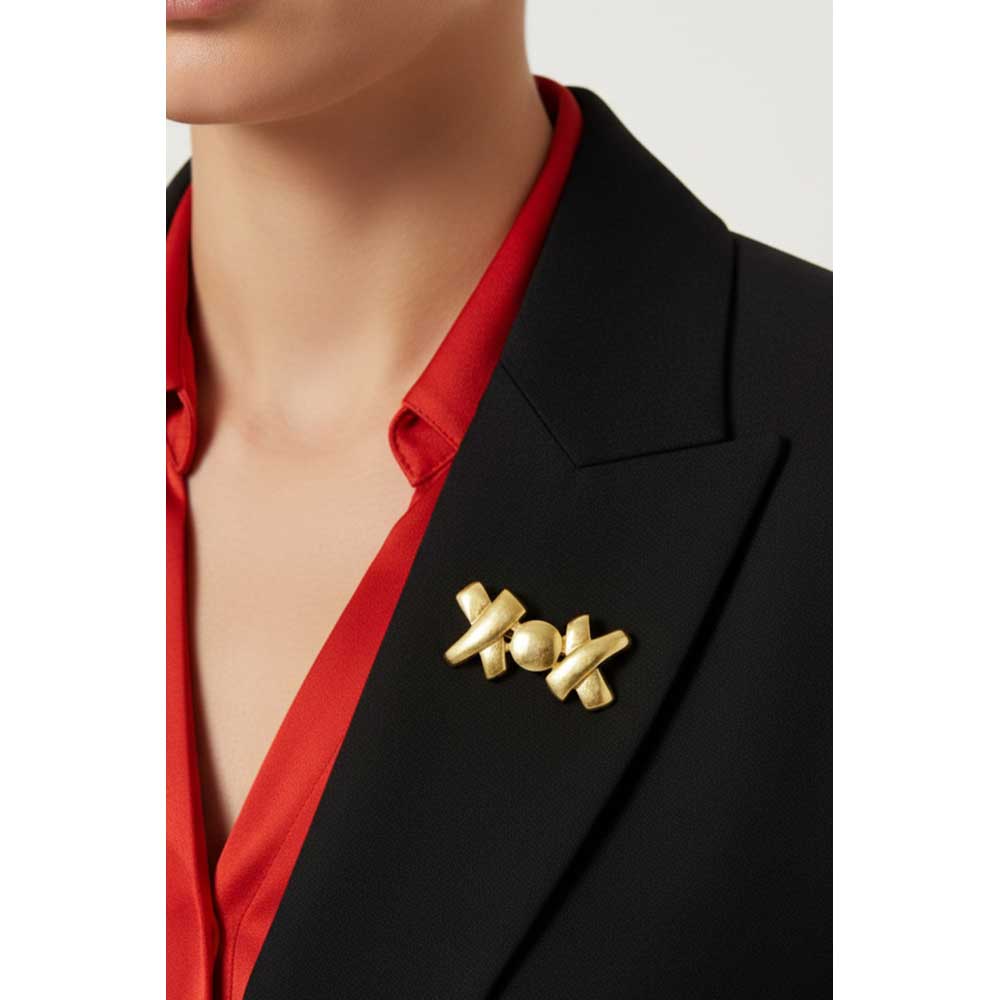 Model wearing gold "XOX" brooch pin on a black jacket with a red shirt - Lilylin Designs