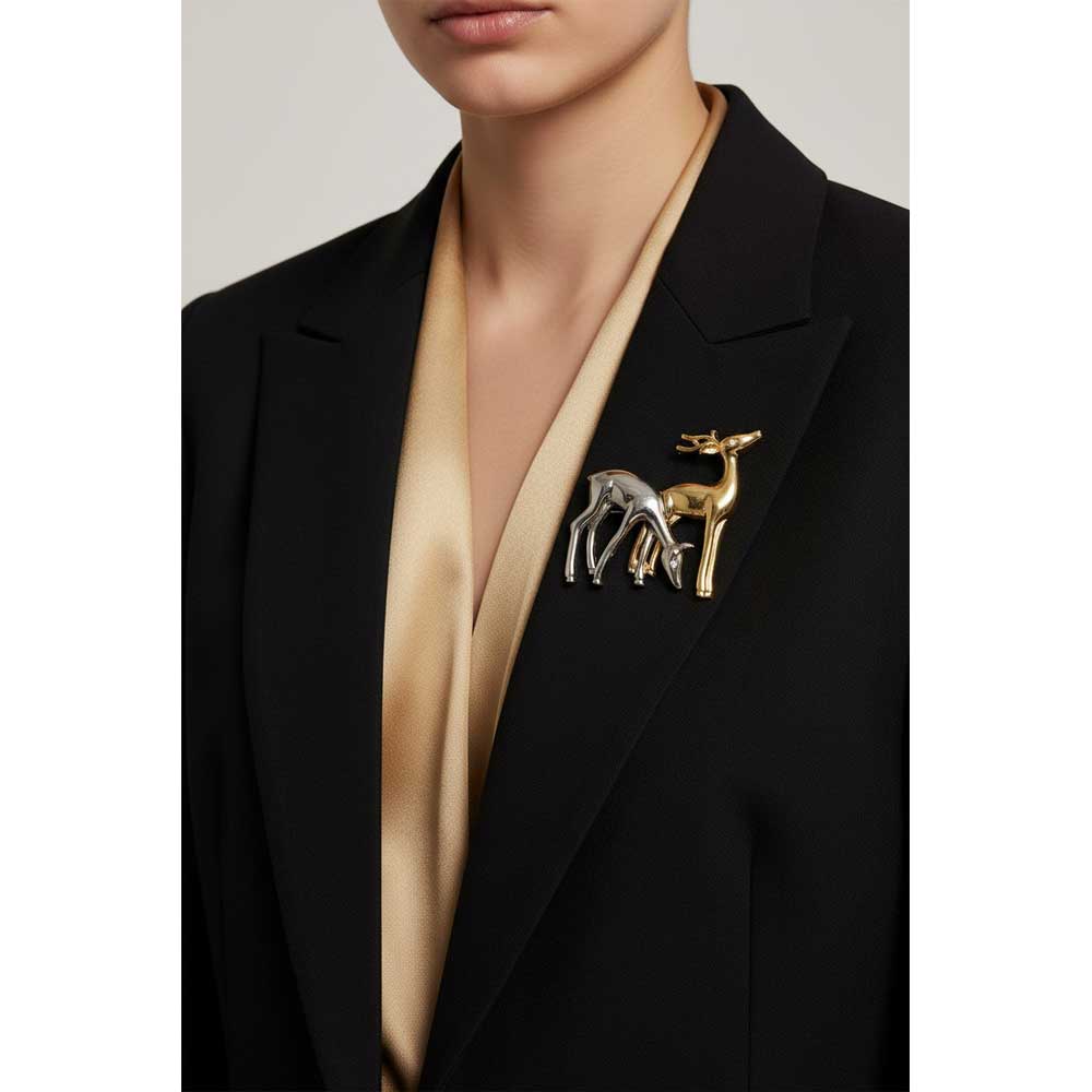Model wearing gold and silver deer brooch pin on a black jacket with a gold top - Lilylin Designs