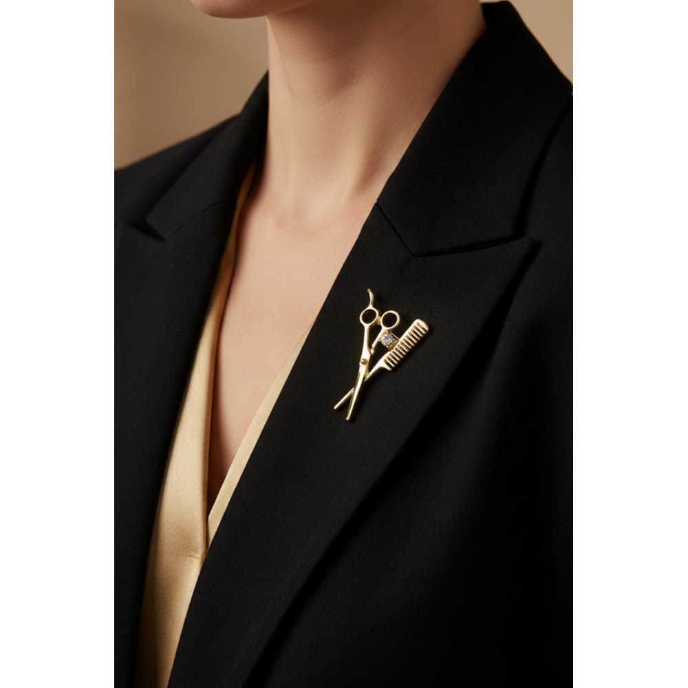 Model wearing gold comb and scissors brooch pin on a black jacket - Lilylin Designs