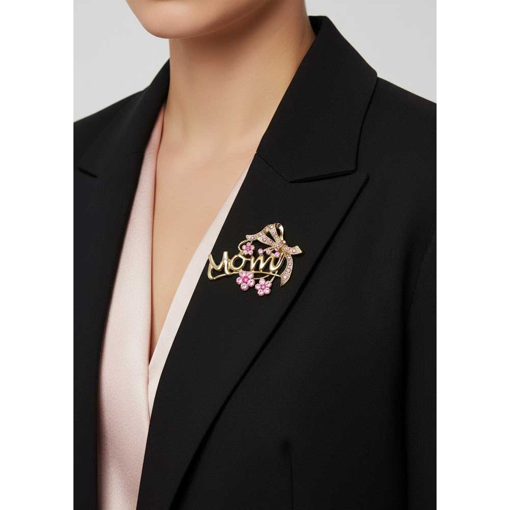 Model wearing gold mom pin with pink crystal flowers and bow pin on a black jacket - Lilylin Designs