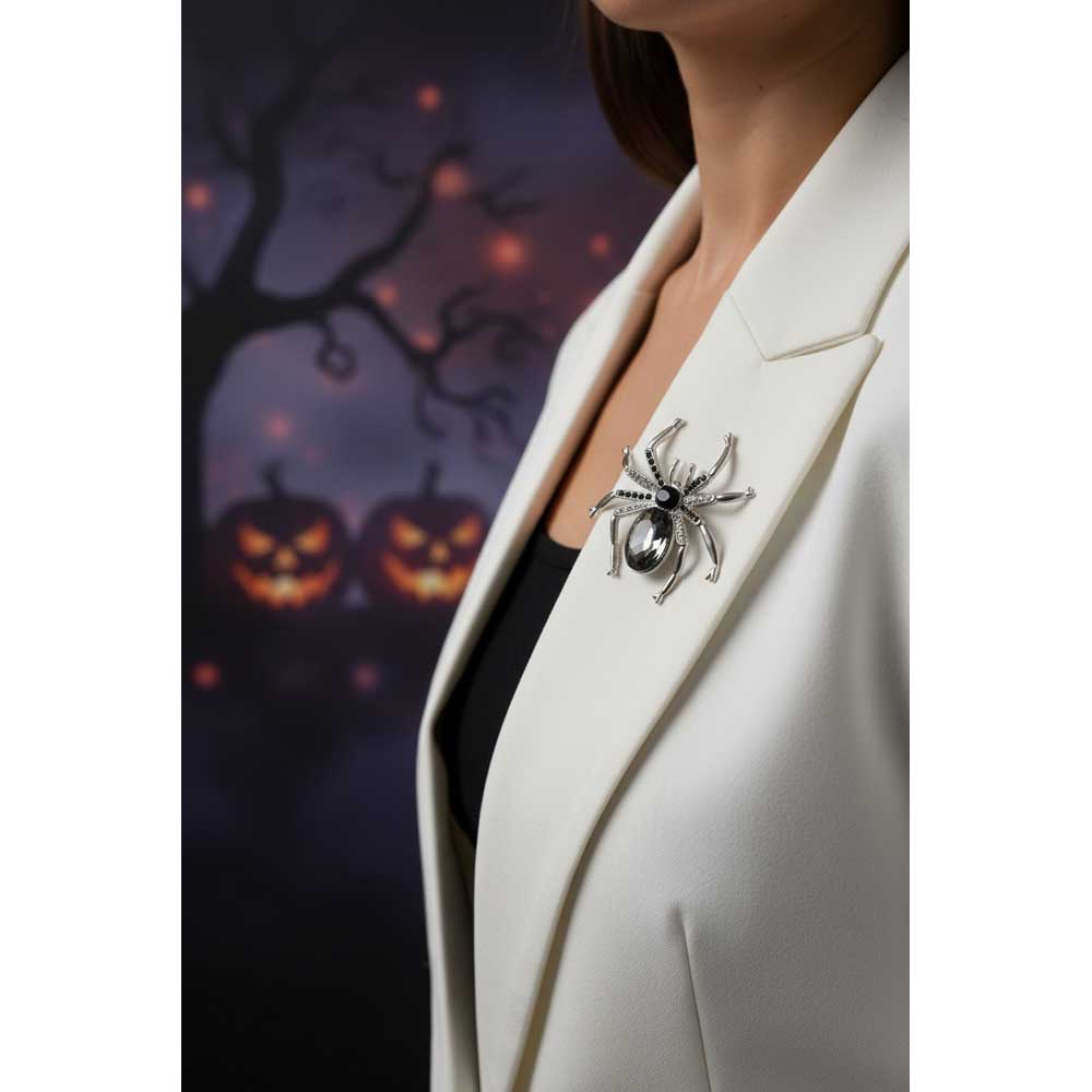 Model wearing black and gray crystal spider brooch pin on a white jacket with a black top, with Halloween background - Lilylin Designs