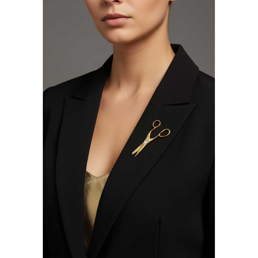 A close-up of a model wearing a black blazer and a gold scissors brooch pinned to the lapel. Lilylin Designs