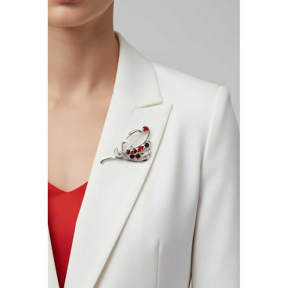 Model wearing red crystal mom and baby swan pin on a white jacket - Lilylin Designs