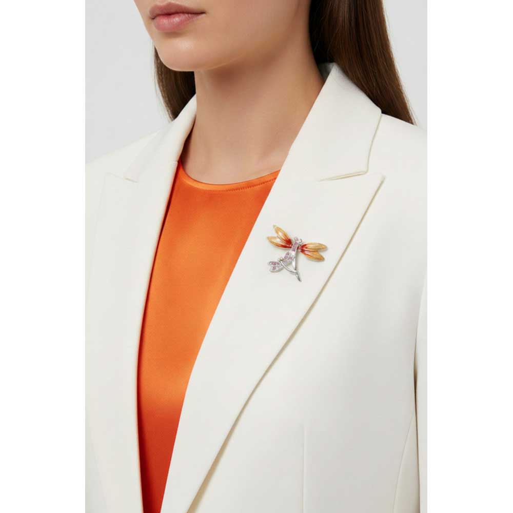 Model wearing orange and pink dragonfly pin on a white jacket with an orange top - Lilylin Designs