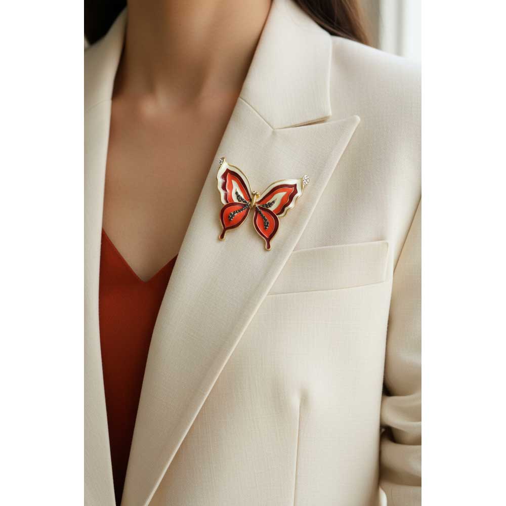 Model wearing orange with gray crystals butterfly brooch pin on a cream jacket - Lilylin Designs