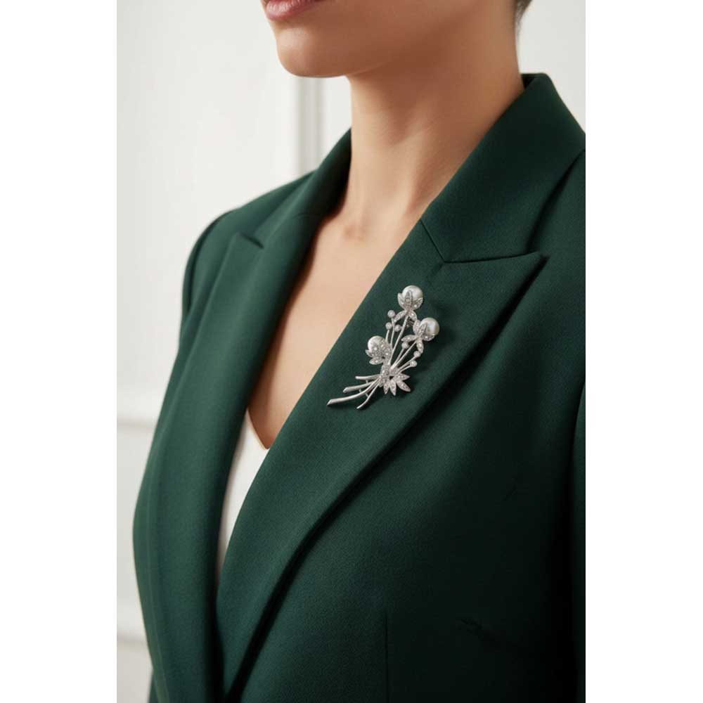 Model wearing pearl and crystal flower buds brooch pin on a dark green jacket - Lilylin Designs