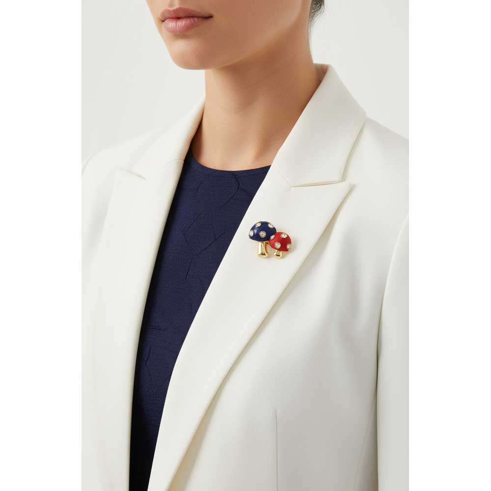 Model wearing red and blue mushroom brooch pin on a white jacket with a navy blue top - Lilylin Designs