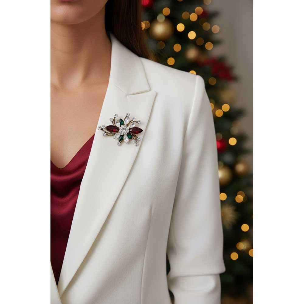 Model wearing red and green Christmas flower brooch pin on a white jacket with a red top and blurred holiday background - Lilylin Designs