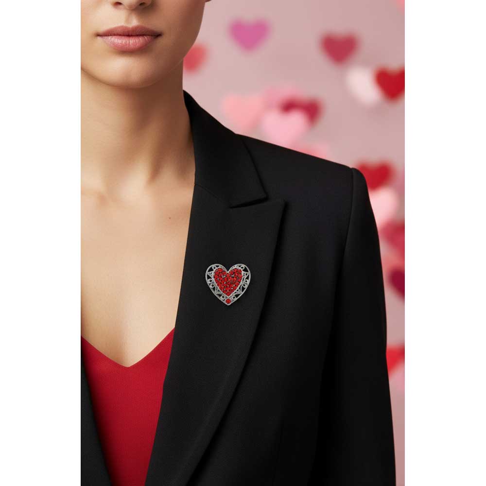 Model wearing red crystal filigree heart brooch pin on  a black jacket with a red top - Lilylin Designs