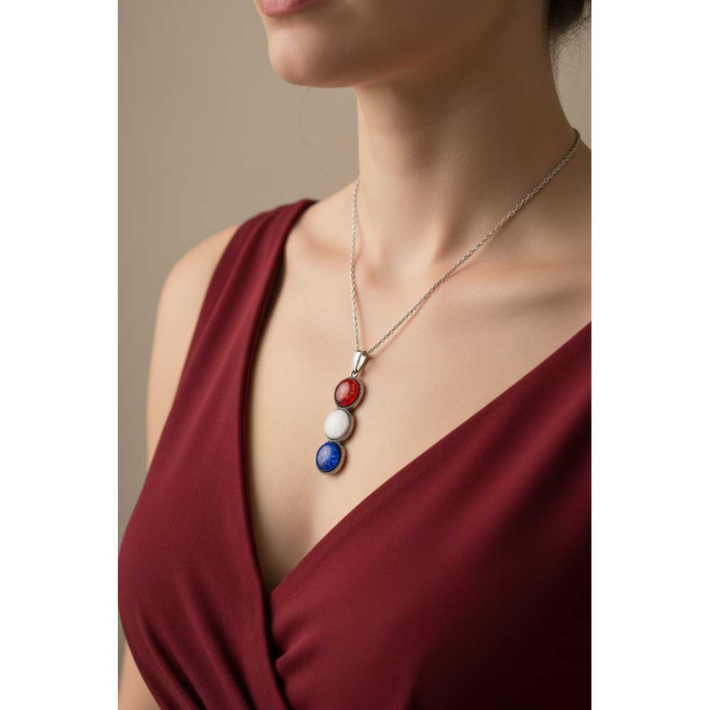 Model wearing Lilylin Designs red white and blue circles necklace with a red dress