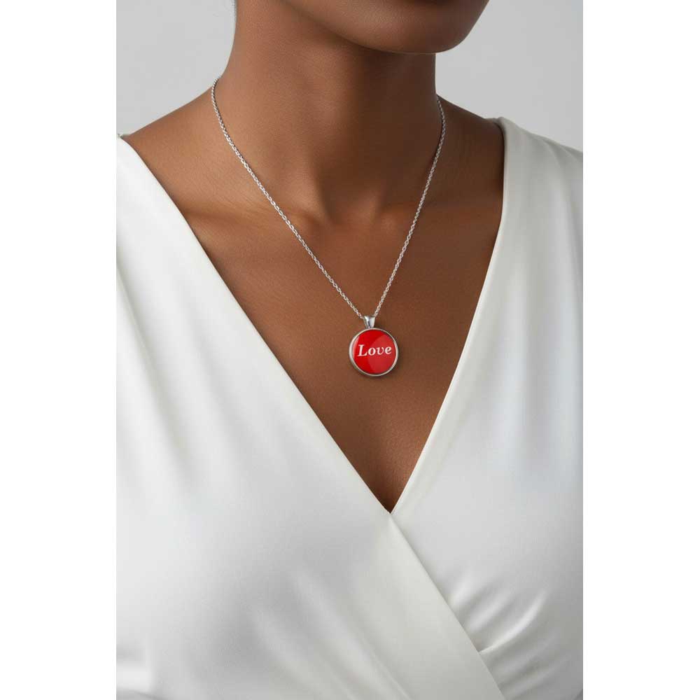 Model wearing Lilylin Designs red with white "Love" necklace with a white dress