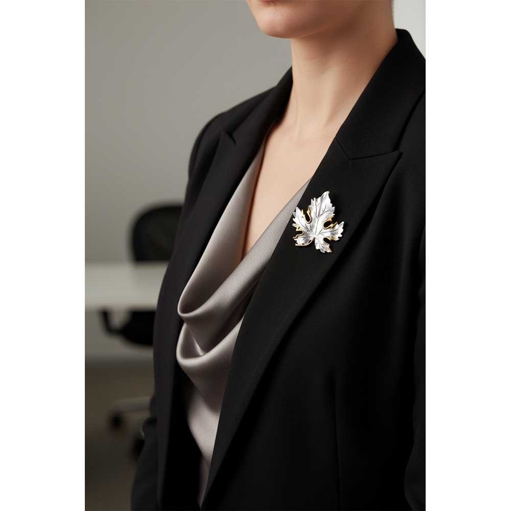 Model wearing silver and gold maple leaf pin on a black jacket - Lilylin Designs