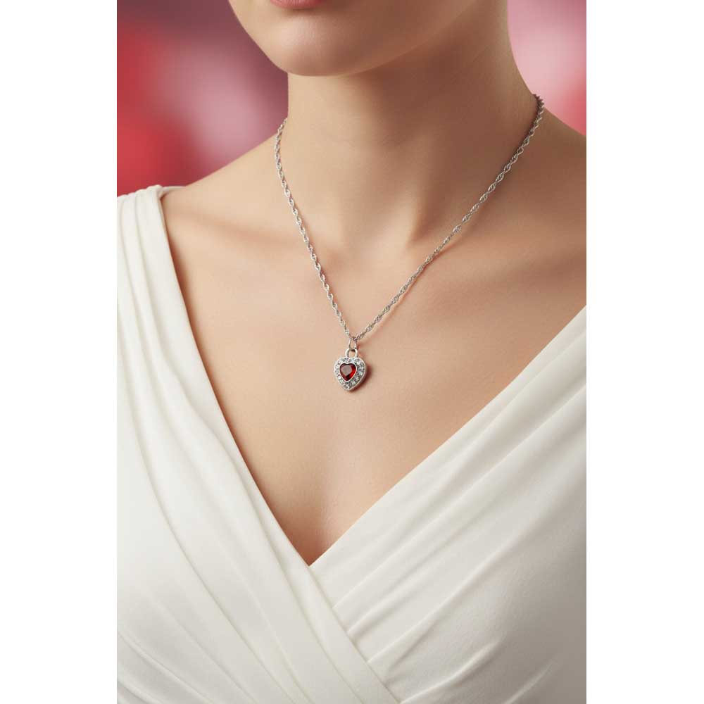 Model wearing Lilylin Designs small red crystal heart necklace with a white dress