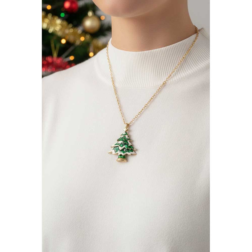 Model wearing snowy Christmas tree necklace with a white sweater and a Christmas tree in the background - Lilylin Designs