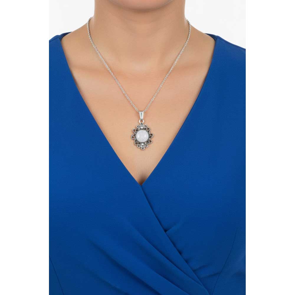 Model wearing Lilylin Designs white flower necklace with a blue dress