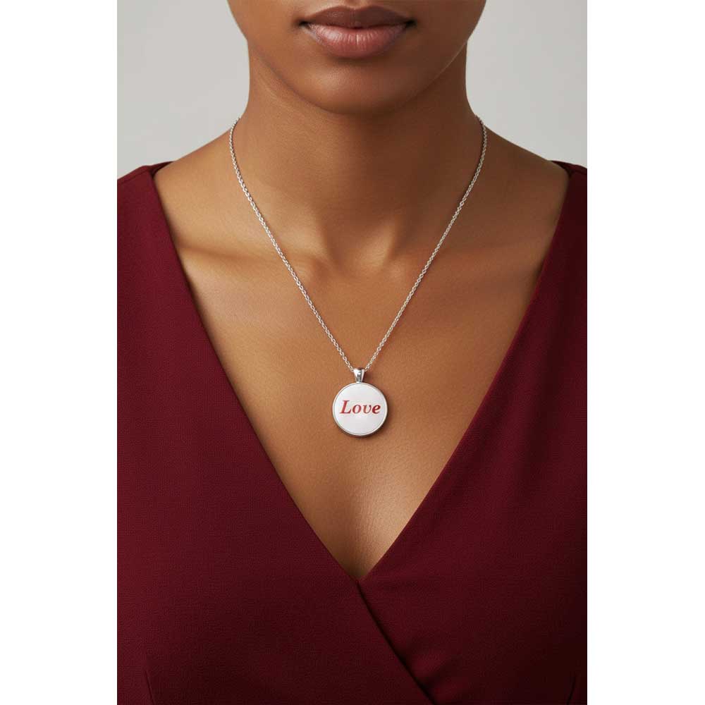 Model wearing Lilylin Designs white with red "Love" necklace with a dark red dress
