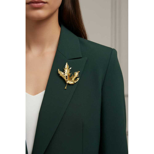 Model wearing antique leaf brooch pin on a dark green jacket with a white top - Lilylin Designs