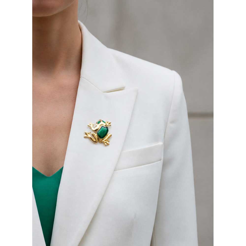 Model wearing green enamel frog brooch on a white jacket with a green top - Lilylin Designs