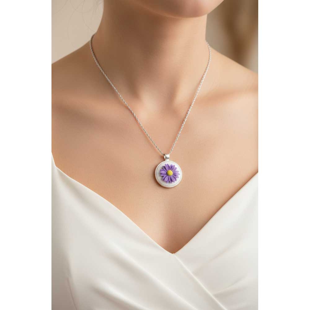 Model wearing Lilylin Designs white with purple daisy handcrafted necklace with a white dress