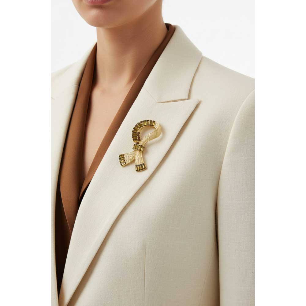 Model wearing ribbon with brown baguettes brooch pin on a cream jacket with a brown top - Lilylin Designs