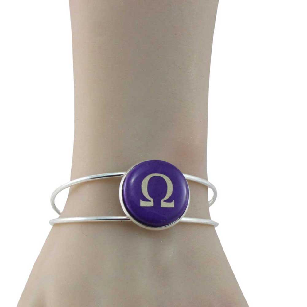 Silver bracelet with a purple button featuring a gold Omega symbol on a model's arm - Lilylin Designs